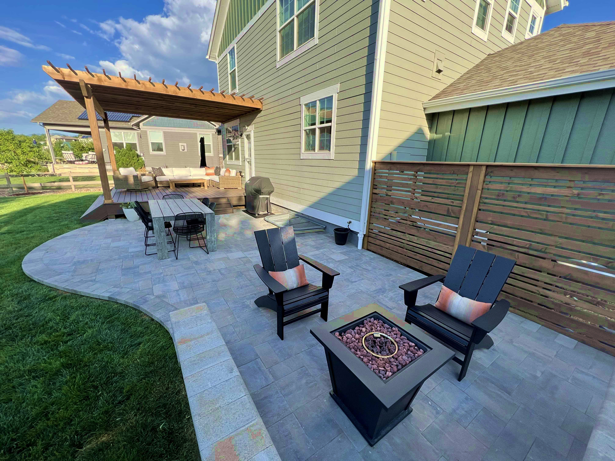 Expansive Denver area patio installation with privacy wall, Trex deck, and wood pergola