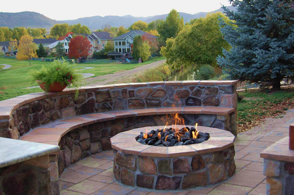 Denver patio design with curved, two-tier seating wall and fire pit