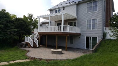 Backyard with two story deck and built in firepit