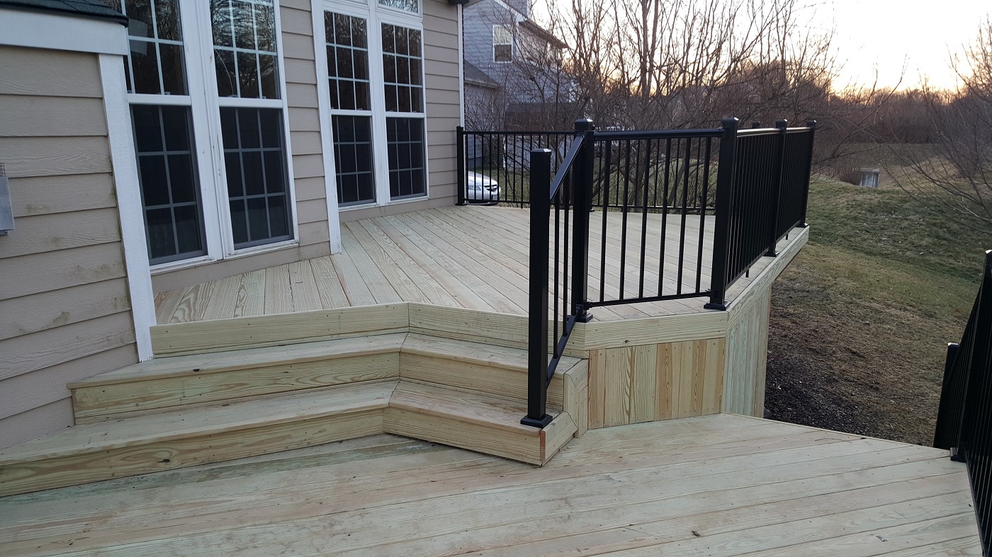 Custom wood deck with black railing.