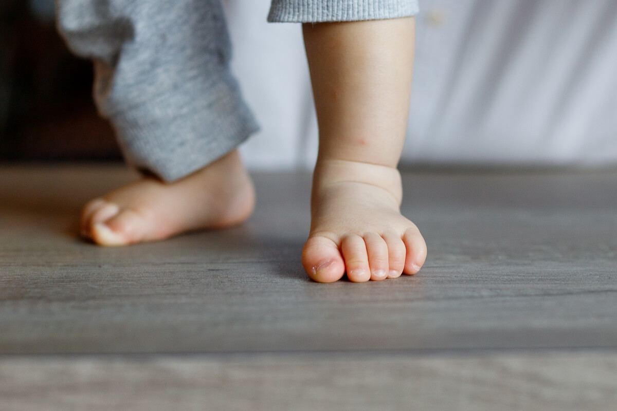 baby feet on wood floor