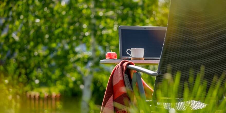 lawn chair with laptop apple and coffee