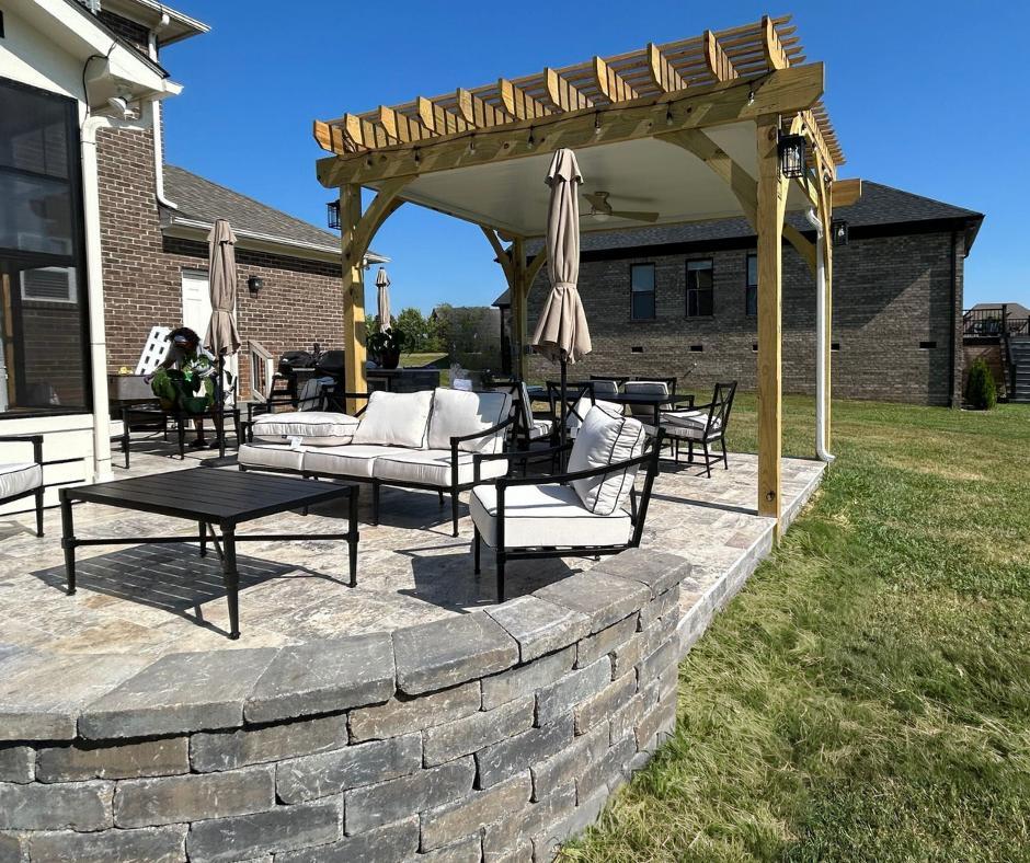 paver patio with wooden pergola in a backyard