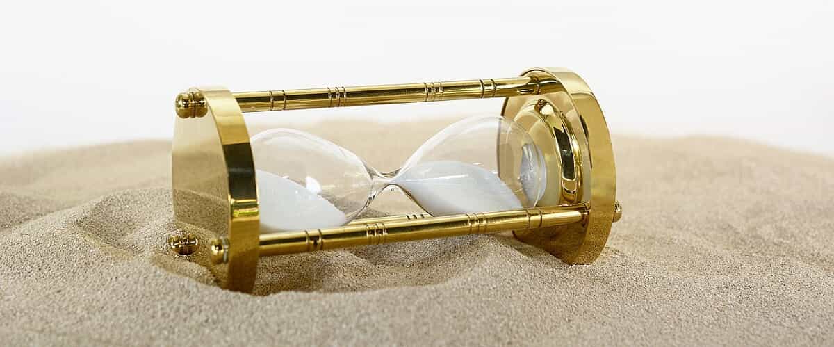 gold hourglass in the sand