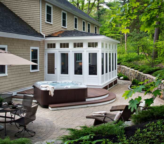 white screened porch with a Jacuzzi next to it on a patio outside