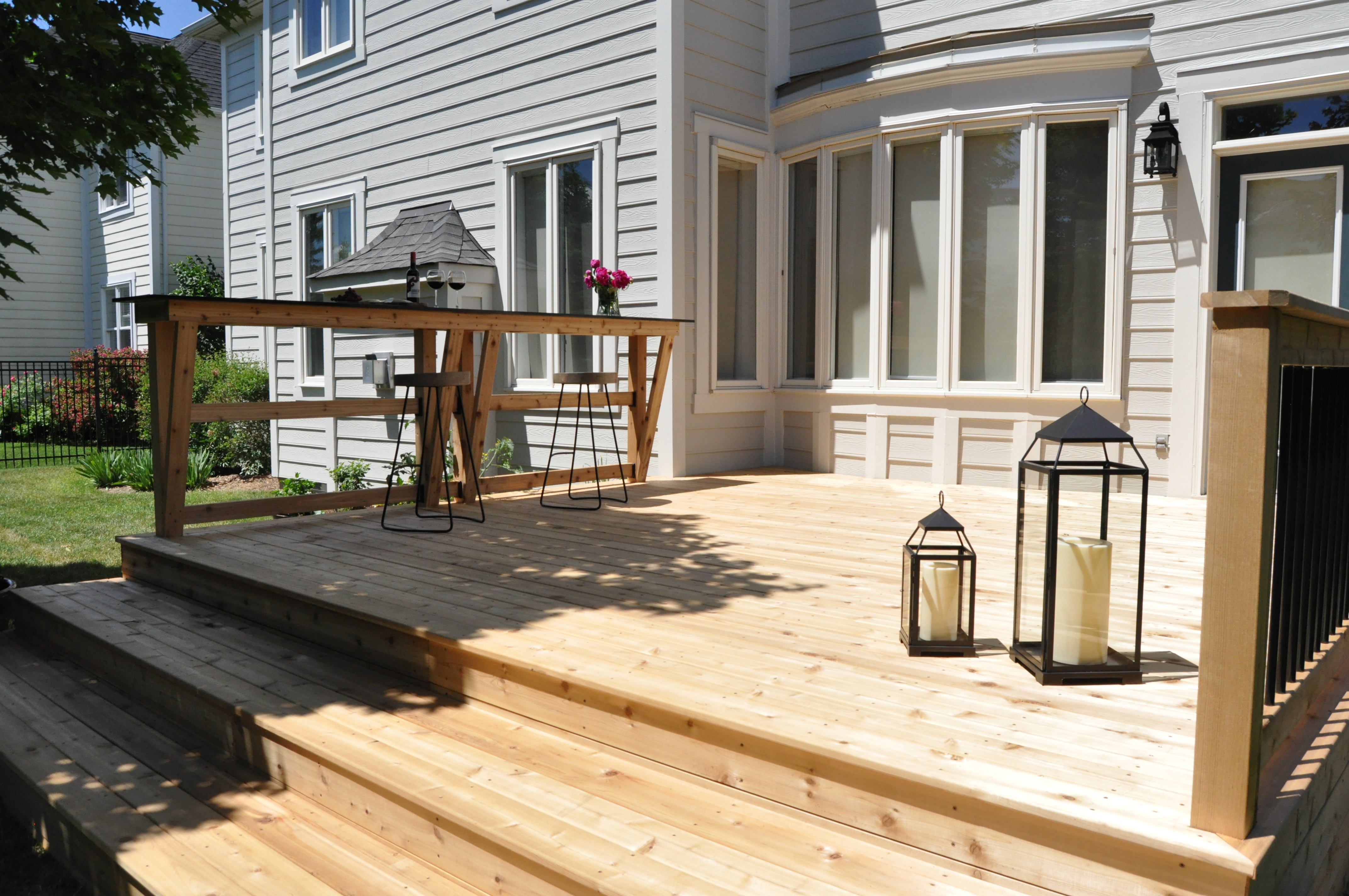 Cedar deck with retaining wall bar.