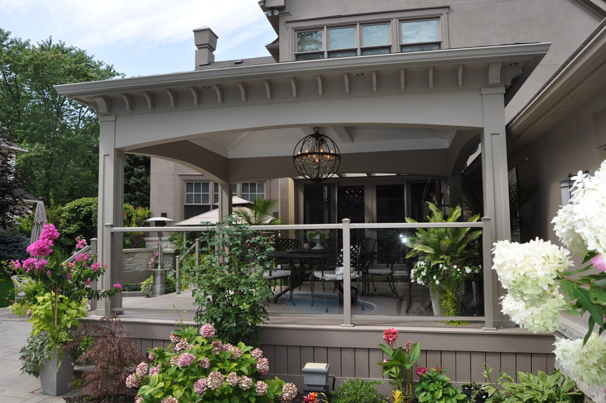 Aluminum and glass railings on a flat-roof open porch.