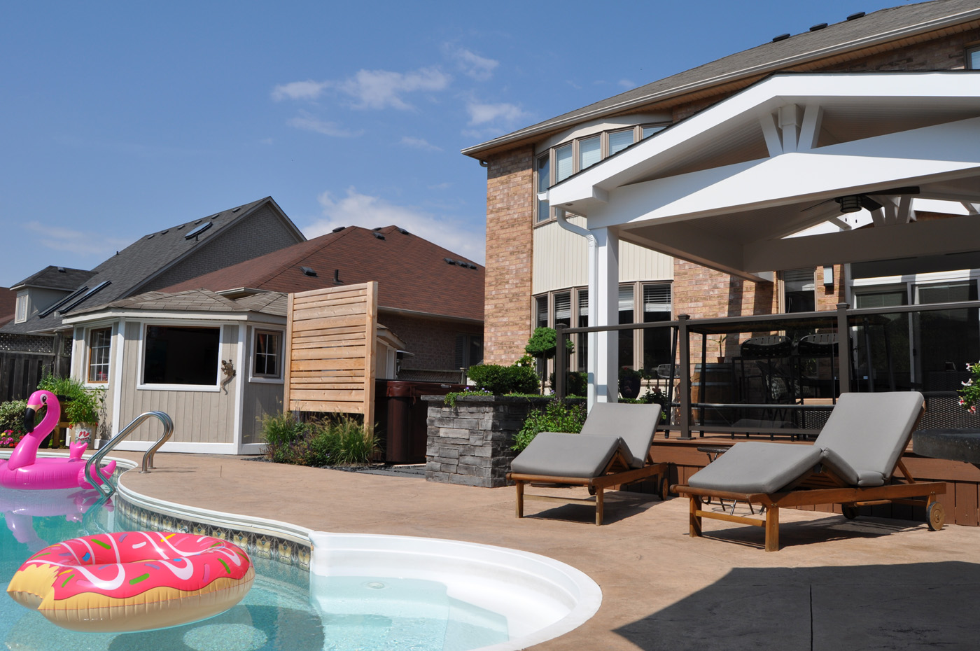 Covered porch overlooking a pool.