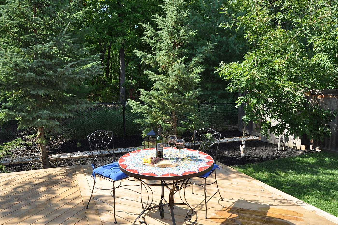 Outdoor wood deck with table and chairs.