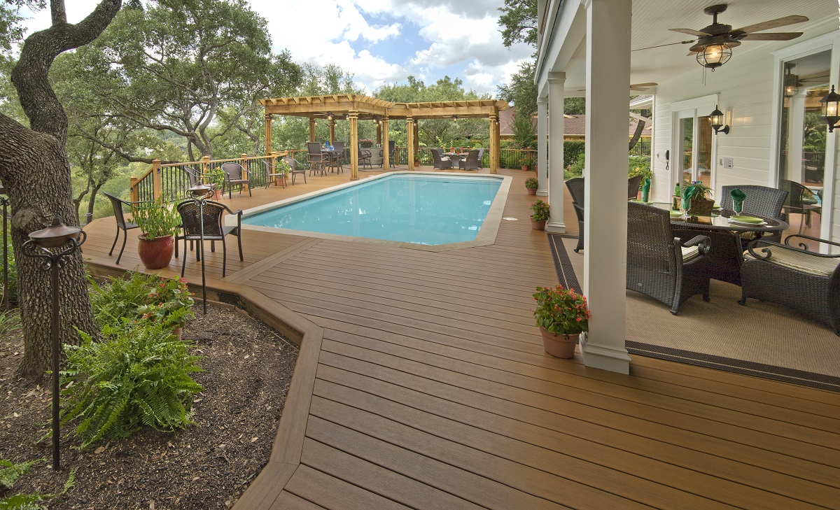 Low maintenance deck with seating area and pool in Houston