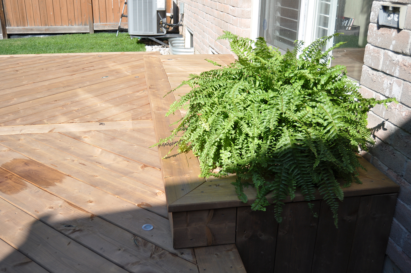 Wood step on deck leading into home.