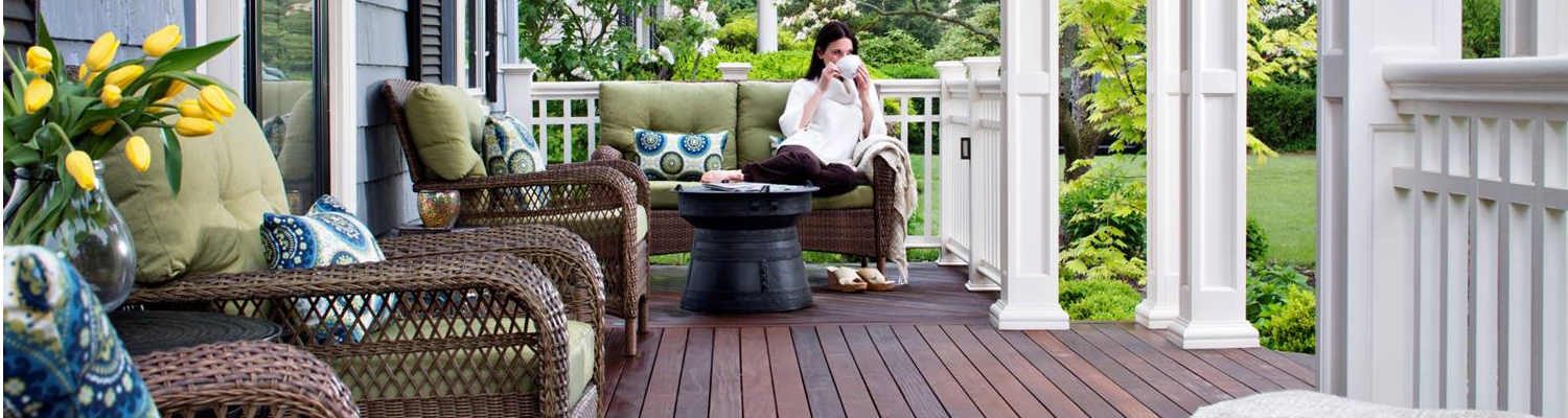 woman having coffee on cozy porch