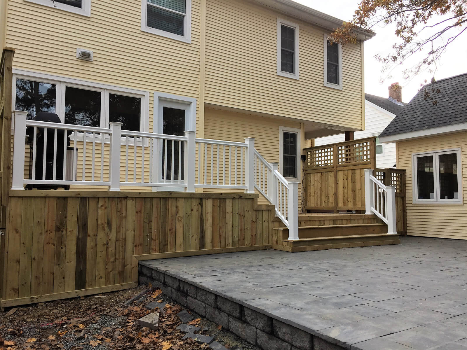 Outdoor wooden deck and hardscaped patio