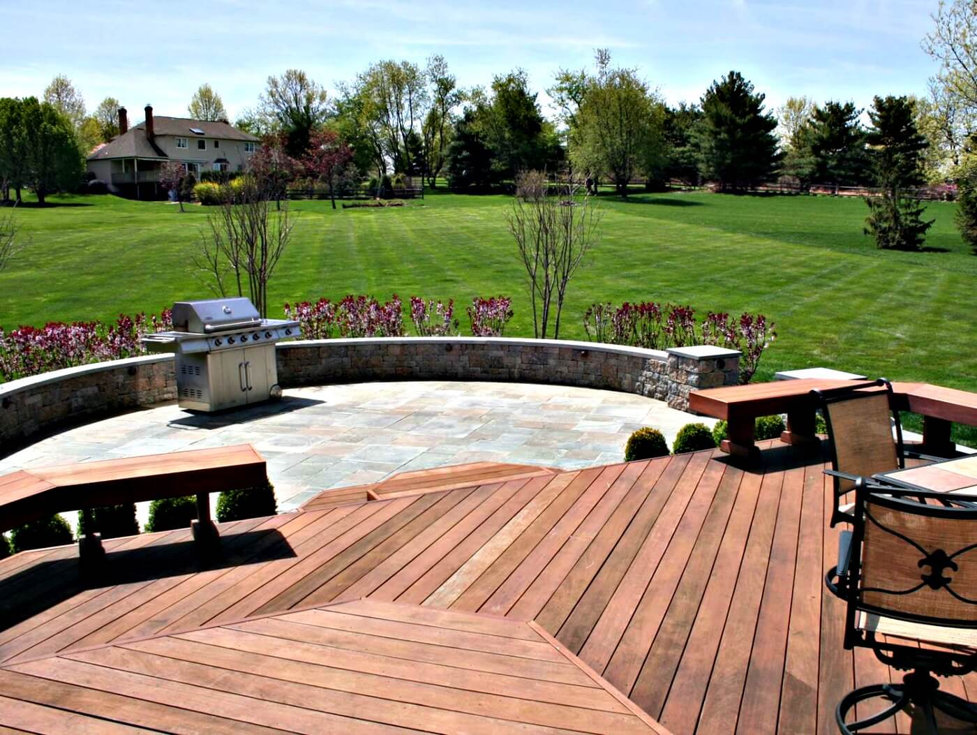 Custom backyard patio and wood deck with outdoor kitchen