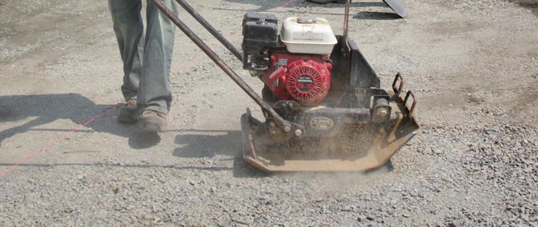 using a plate compactor to prepare for stone pavers
