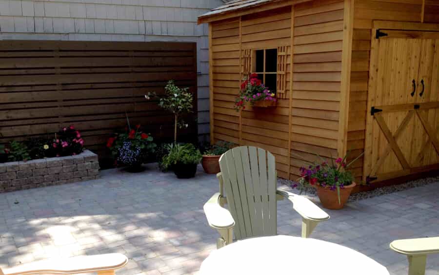 Stone patio with planter and shed