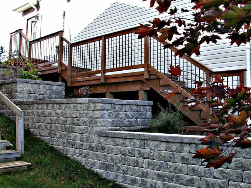 stone retaining wall next to wood stairs