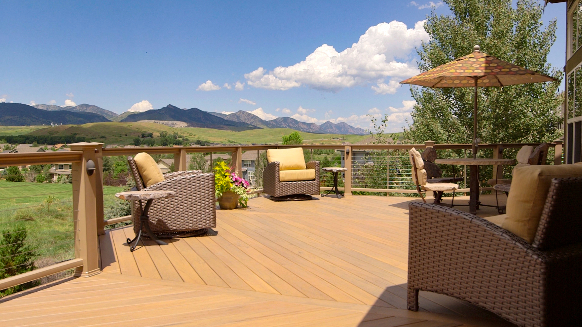 brown wood deck overlooking mountains